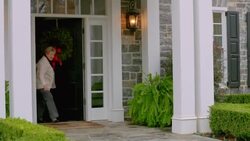 Excited grandmother opens door and claps, greets grandchildren with hugs (dolly-shot) Stock Footage