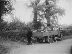 Police in Britain part 3 - countryside policeman inspects a lorry of scrap. On duty at the horse races and at a fairground. Bandages the knee of a little girl. Policemen with dogs. Stock Footage