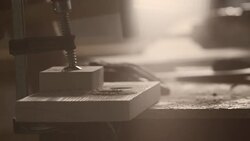Carpenter hammering nail in piece of wood Stock Footage