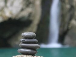 Balanced stones on waterfall background Stock Footage