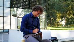 Multi tasking in office park Stock Footage