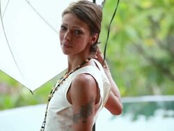 MS PAN Female models under lighting umbrellas and other on ground / Montezuma, Punteranes, Costa Rica Stock Footage