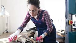 Young female sculptor working with a log Stock Footage