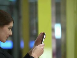 HD: Woman Photographing Clothes In Window Display Stock Footage