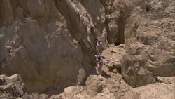 Archaeologists climb a rocky hill near an abandoned emerald mine in the ancient town of Sikait, Egypt. Stock Footage