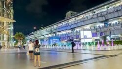 Time lapse of people in front of shopping mall and sky train station background Stock Footage