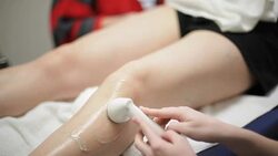 Patient Leg Pain Treatment with Ultra Sound at Clinic Health Center Stock Footage