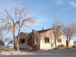 MS View of Abandoned and partially destroyed house with dry trees / San Pedro de Valdivia, Atacama desert, Chile Stock Footage