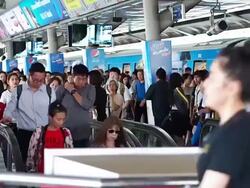 The escalators in the train station crowded with passengers for sky train Stock Footage