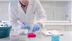 MS PAN Scientist in research laboratory labeling centrifuge test tubes Stock Footage