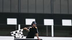 Stock car race official waves checkered flag Stock Footage