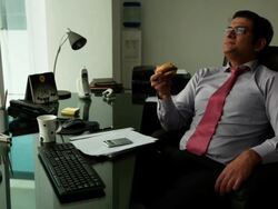 Businessman eating a burger in an office  Stock Footage