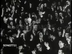 1933: FRANKLIN D. ROOSEVELT WINS ELECTION: HA WS Crowd cheering. WS Newly elected President Franklin D. Roosevelt 'FDR' (1882-1945) standing at building entrance w/ cane & assistant, waving. Instructional Video