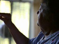 CU Elderly woman looking at syrringe in light preparing to give herself injection / Minneapolis, Minnesota, United States Stock Footage