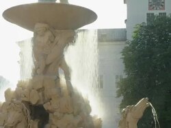 TU Residenzbrunnen. The fountain was executed by Tomasso di Garona between 1656 to 1661. It is made of marble, considered the largest baroque fountain of Central Europe. Neue Residenz in background Stock Footage