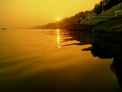 Boat point of view tilt up tilt down from water to wide shot Ganges River with buildings on shore / Varanasi, India Stock Footage
