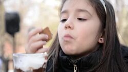 Girl eating hot chocolate. Stock Footage