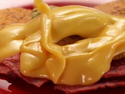 CU PAN Melted cheese poured over tortilla chips and sprinkled with chopped scallions to make nachos / Los Angeles, California, United States Stock Footage