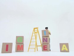 Time lapse of man stacking boxes with letters to spell word imagine Stock Footage