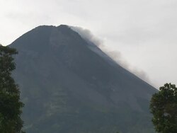 Wide shot of steam rising from lava dome at Merapi volcano; Central Java, Indonesia. 29 October 2010 Stock Footage