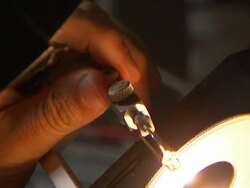 A pair of hands adjust dials on a light microscope. Stock Footage