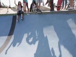 Teenagers cheering friend at skateboard park Stock Footage