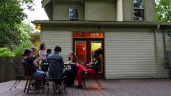 MS Family eating birthday cake together on backyard patio of home on summer evening Stock Footage