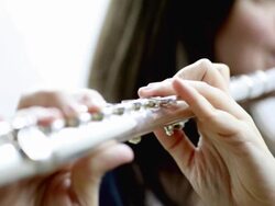 Young woman playing flute Stock Footage