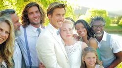 Smiling bride and groom surrounded by friends and family Stock Footage