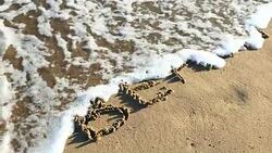 BEACH written in sand Stock Footage