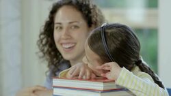 Mother helping daughter with homework Stock Footage