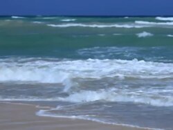 Good Looking young man jogs on th beach and hi-fives another jogger Stock Footage