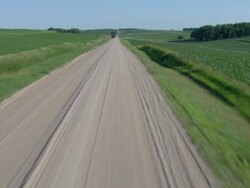 Following a gravel road to meet an oncoming ambulance Stock Footage