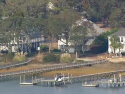 MS AERIAL Shot of houses surrounded by trees at Holden beach / North Carolina, United States Stock Footage