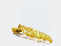 MS SLO MO Yellow capsicum falling on floor against white background / Vieux Pont, Normandy, France  Stock Footage