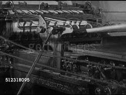 1952: THE ELKHORN INDEPENDENT: VS Rollers of flat bed press turning, sheets coming out of printing press, wheels spinning, Claude Eames checking first completed copy of newspaper. Wisconsin, WI Instructional Video