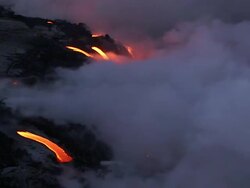 Medium Long Shot static - Smoke plumes billow from burning lava as it flows into the sea. / Hawaii, USA Stock Footage