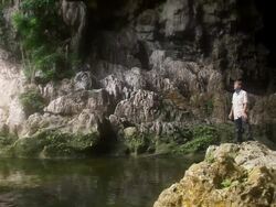 MS Shot of man in cave with water below / aguacate, toledo, belize Stock Footage