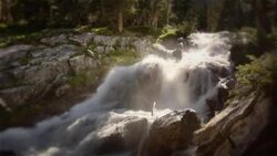 A river rushes over rocks, spraying mist into the air. Stock Footage