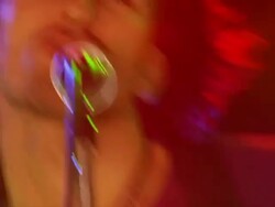 Slow motion medium shot zoom in to close up young man singing and playing electric guitar Stock Footage