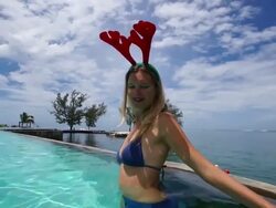 Reindeer ears woman for Christmas in a Polynesian swimming pool Stock Footage