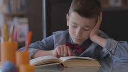 Little boy doing homework Stock Footage
