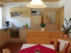 MS PAN View of Modern Bavarian kitchen with vegetables on table / Lenggries, Bavaria, Germany Stock Footage