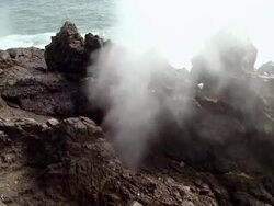 MS Shot of Water sprays from holes in rocks as waves crash / Punta Hermosa, Lima, Peru Stock Footage