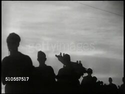 1945: YUGOSLAVIA WARFARE: VS Silhouettes of partisan soldiers walking. VS Yugoslavian soldiers running down war torn streets, Belgrade. VS Anti-tank artilleries firing. (POV behind) MS Sniper laying on balcony overlooking streets. WWII, Nazi Germany Instructional Video