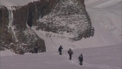 Hikers move across a snow-covered Patagonian plateau. Stock Footage