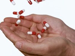 MS SLO MO Capsules Falling into two Hand of Man / Vieux Pont, Normandy, France Stock Footage