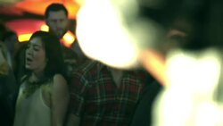 Friends dance and cheer for band in the front row of an outdoor rock concert Stock Footage