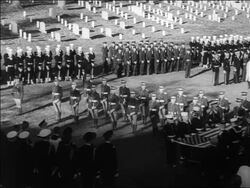 B/W 1963 high angle Irish honor guards lowering guns at JFK's funeral / US military in background / Arlington Stock Footage