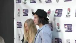 Nick Simmons & Rebecca Szulc on red carpet at Mending Kids Music On A Mission at Lucky Strike in Hollywood Stock Footage